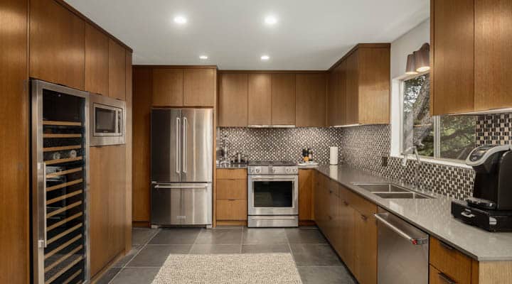 A modern kitchen with stainless steel appliances and wooden cabinets