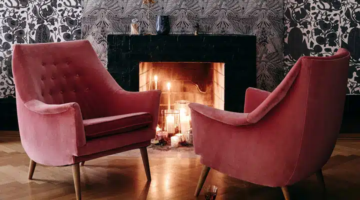 A living room filled with furniture and a fire place sitting in a chair