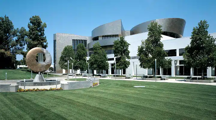 A large building with grass and trees