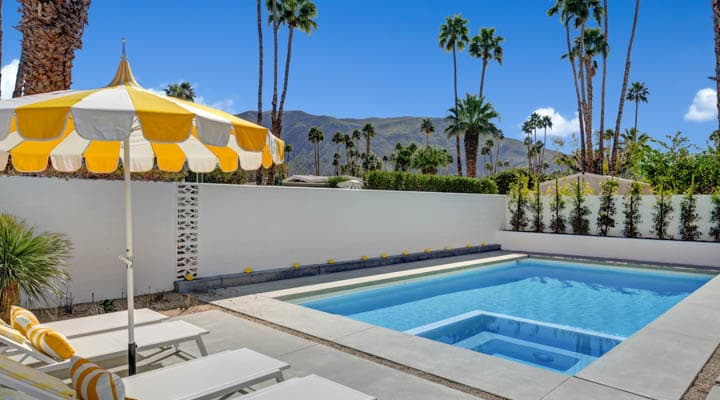 A pool next to a palm tree
