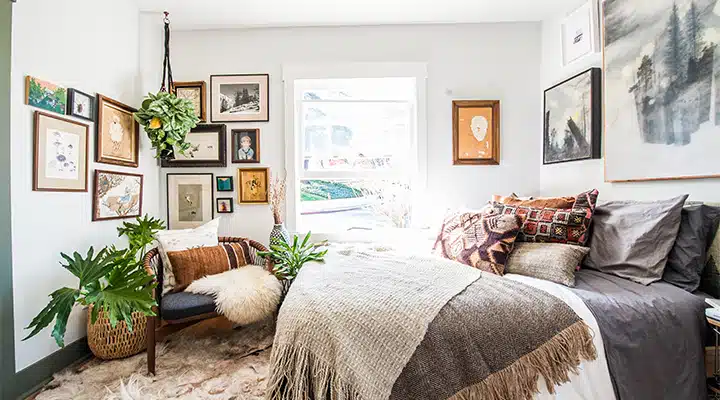 A bedroom with a bed and a couch in a living room