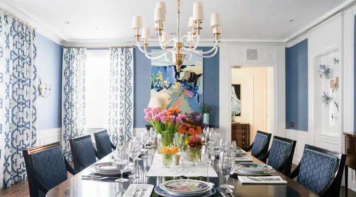 A dining room filled with furniture and vase of flowers on a table