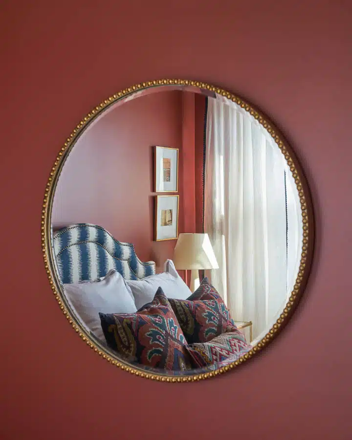 A bedroom with a large mirror