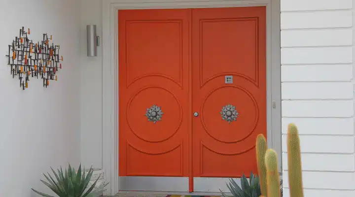 An orange hanging from a door
