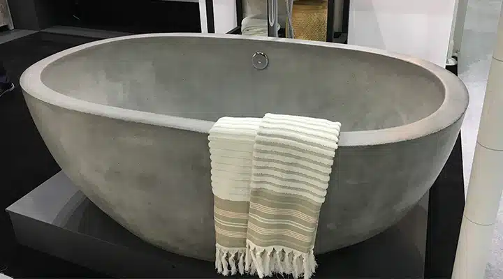 A large bowl with a white tub sitting next to a sink