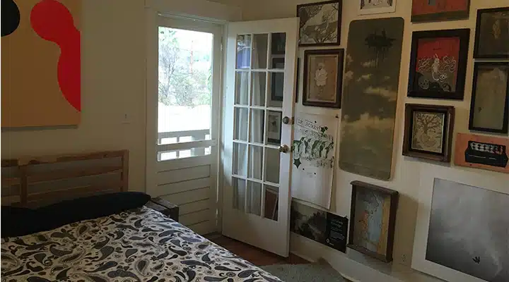 A bedroom with a bed and a window