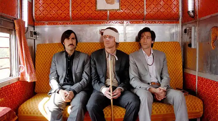 Adrien Brody et al. that are sitting on a couch