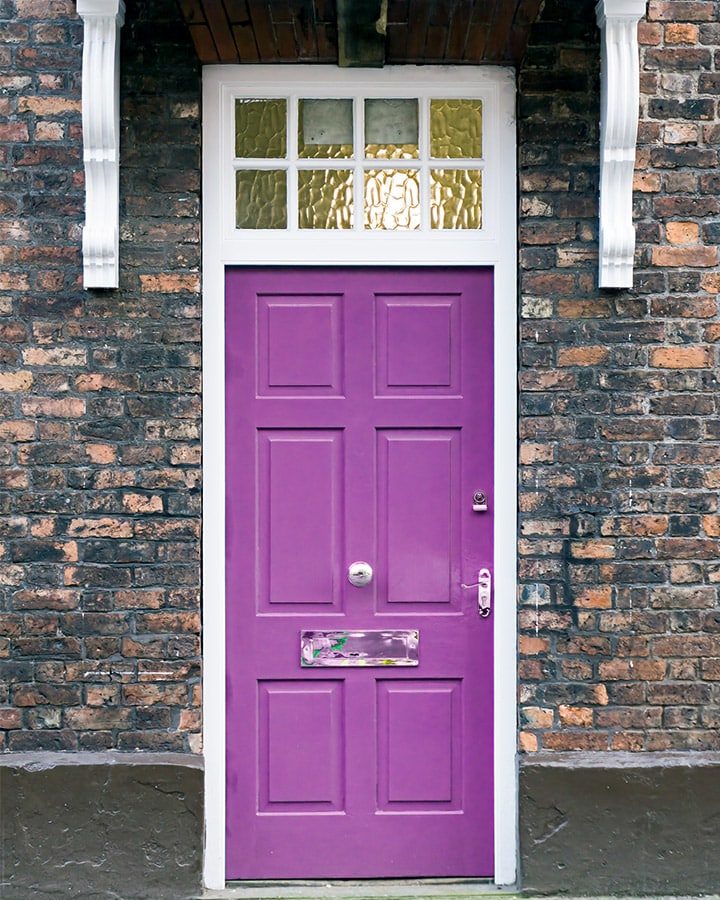 A large brick building with a purple door
