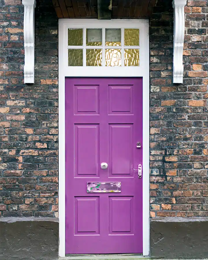 A large brick building with a purple door