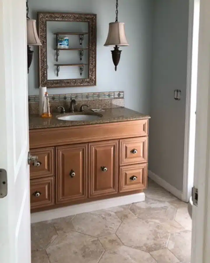 A kitchen with a sink and a mirror