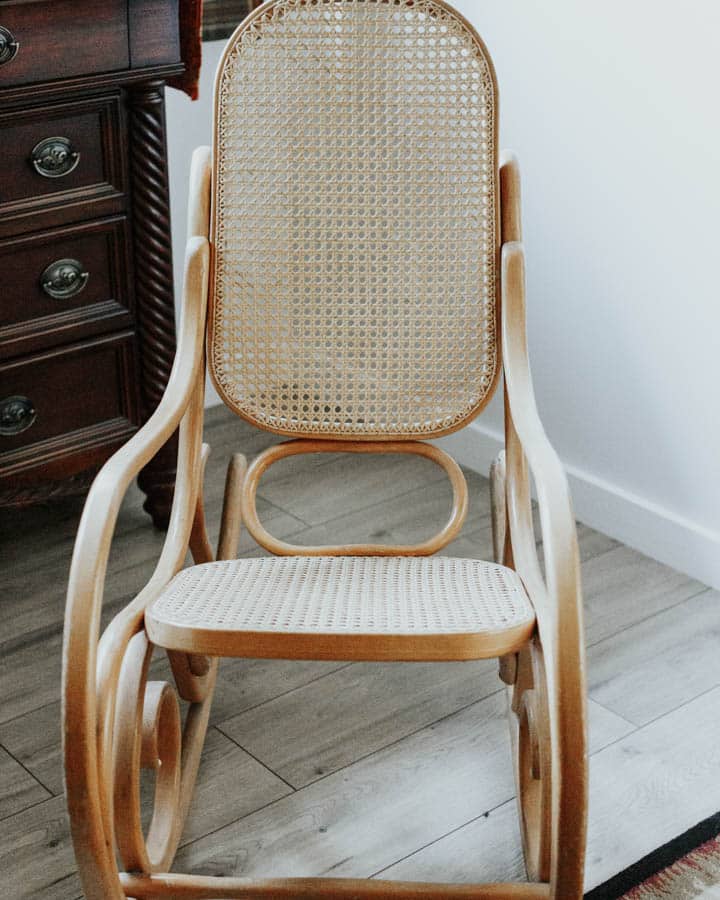 A desk with a basket on a wooden chair