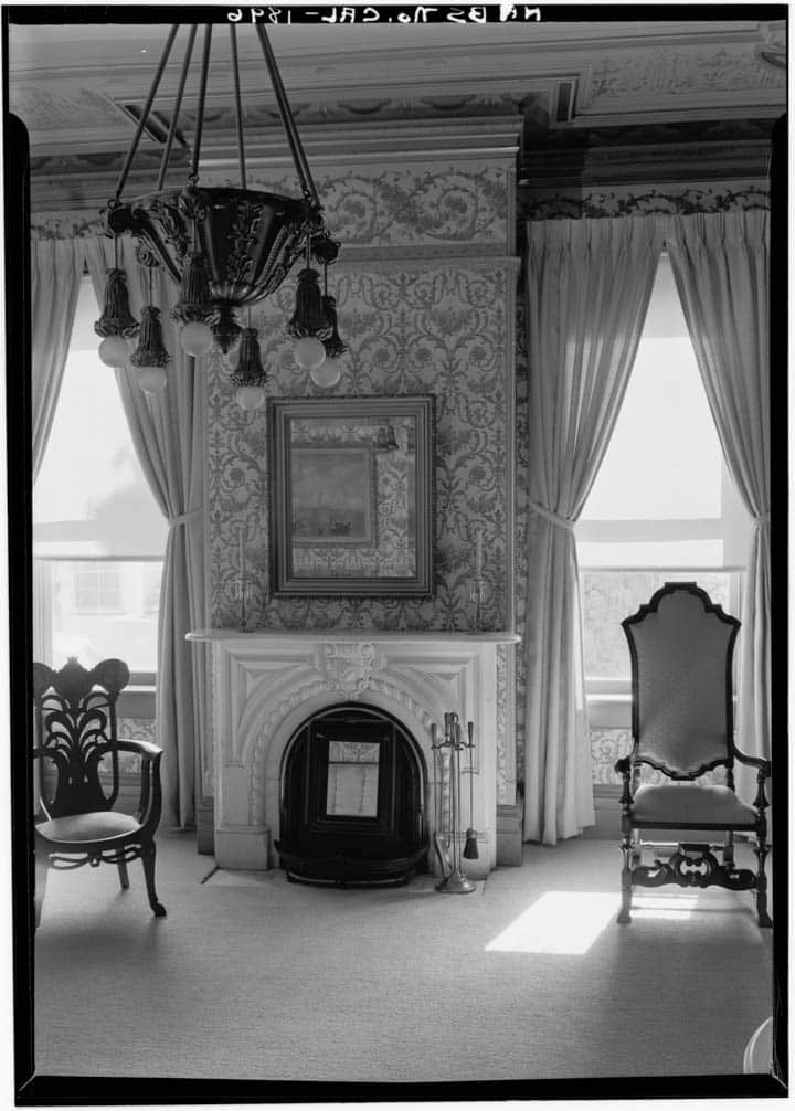 An old photo of a living room filled with furniture and a window