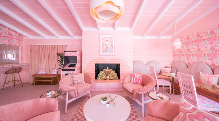 A living room filled with furniture and a pink chair